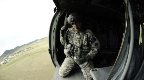 Wide angle shot from in Black Hawk helicopter flying and soldiers in the Stock Footage 52701741