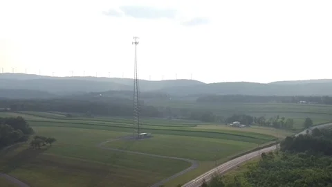 A Wide Angle Shot of a Cellular Tower and Windmills Vídeo Stock 158442921