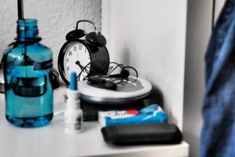 Wide angle shot of a clock, bottle and other objects on a table 写真素材