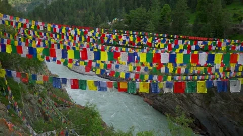 Wide angle shot of colorful Buddhist Tibetan Prayer flags above the river Stock Footage 342314978