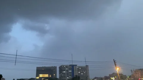 Wide Angle Shot of Dense Overcast Monsoon Sky and Power Lines Over City Stock Footage 343886506