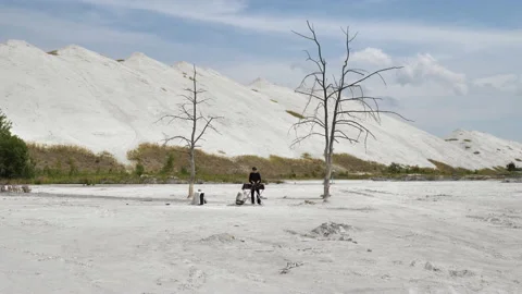 A wide-angle shot of a DJ set in the middle of a desert of chemical waste Stock Footage 172296645
