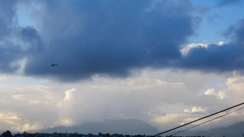 Wide angle shot of a helicopter or chopper flying in a sky with dark clouds Stock Footage 258714812