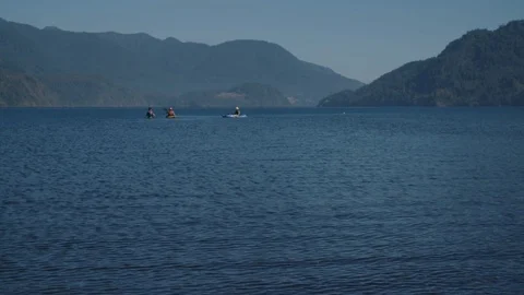 Wide Angle Shot Of A Lake In Chile With Kayakers And Canoes Flipping Over 스톡 동영상 70379260