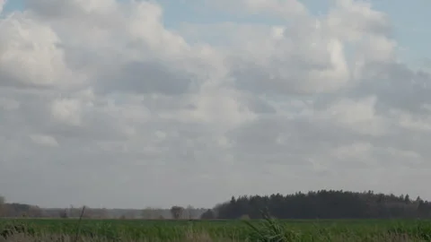 Wide angle shot of open fields under a dramatic cloudy sky. 4K 60fps. Vídeos de archivo 333995447