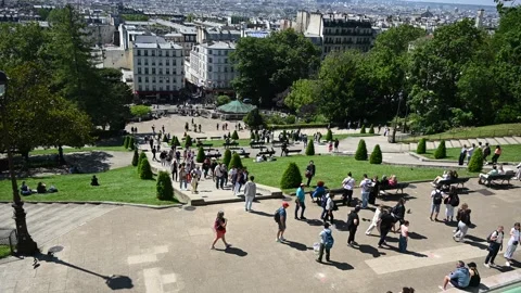Wide-angle shot of people strolling in a sunny Parisian park at Montmartre,.. Stock Footage 338365433