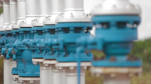 Wide Angle Shot of Pipes and Valves at an oil and gas Oil Well Stock Footage 45236779