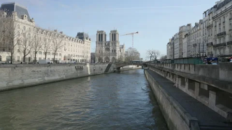Wide-angle shot from Pont Saint-Michel toward Notre-Dame de Paris at sunset Stock Footage 323912412