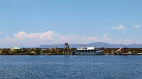 Wide-angle shot of sailing past the Uros Islands Video stock 68401573