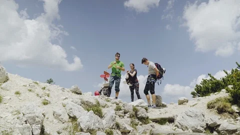Wide angle shot of three friends having a break in the mountains Stock Footage 98694168