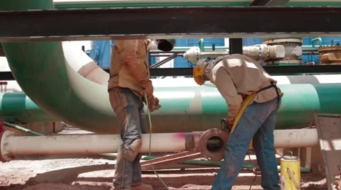 Wide Angle Shot of two oil and gas workers Stock Footage 45236796