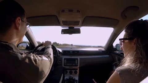 Wide angle shot of a young couple driving in cars  Stock Footage 90058437