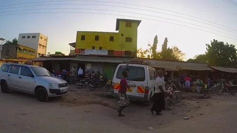 Wide-angle side-scrolling shot of an African town Video stock 79020047
