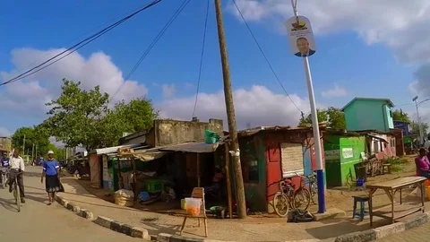 Wide-angle side-scrolling shot of an African town 3 Stock Footage
