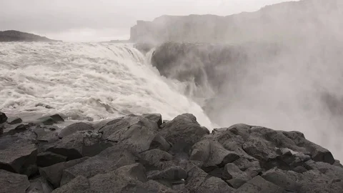 Wide angle sitting on the edge of Dettifoss waterfall in Iceland Video stock 81843803