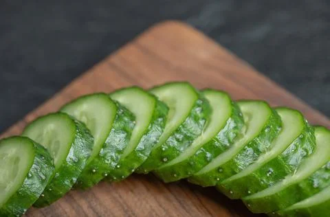 Wide angle sliced cucumber on black background Stock Photos