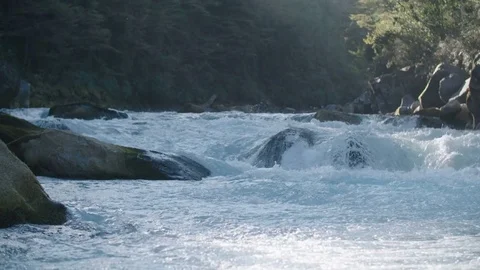 Wide Angle Slow Motion Of Aqua Colored Whitewater Rapids In A Patagonia River Stock Footage 70375124