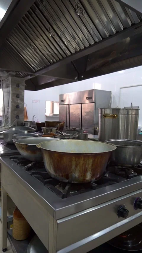 Wide angle slow motion panning of a commercial restaurant kitchen with stainless Stock Footage 341514013