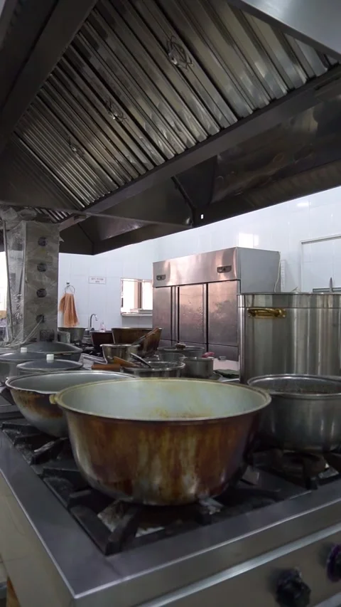 Wide angle slow motion panning of a commercial restaurant kitchen with stainless Stock Footage 341514018