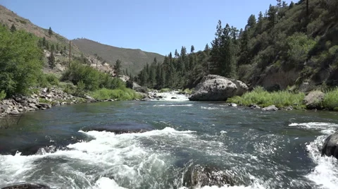 Wide-angle, slow motion shot of a section of rapids on the Truckee river Stock Footage 42960385