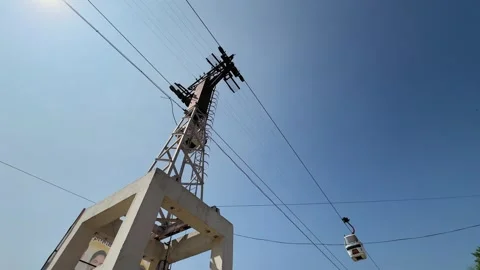 A wide angle static shot showing two cable car gondolas crossing each other on 動画素材 331092950