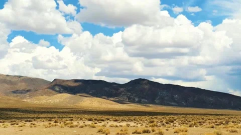 Wide angle steady shot of a dry desert landscape under a summer sky Stock Footage 342331309