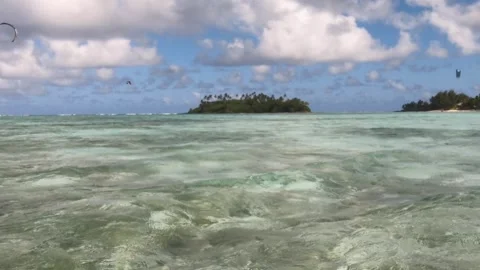 Wide angle still view of kite surfers surfing in crystal clear blue lagoon salt  Stock Footage 250400744