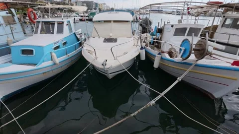 Wide angle tilt up of boats in organized Greek island marina in summer Stock Footage 337458136