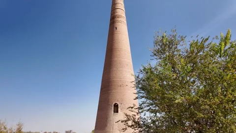 Wide angle tilt up view of tall brick minaret, Kutlug-Timur, Kunya-Urgench Stock Footage 347052079