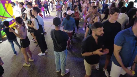 Wide Angle Tilted Down Shot Of Large Crowds Of People Walking Through Amusement Stock Footage 224128007