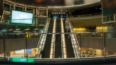Wide angle time lapse of 3 busy escalators Stock Footage 49604751