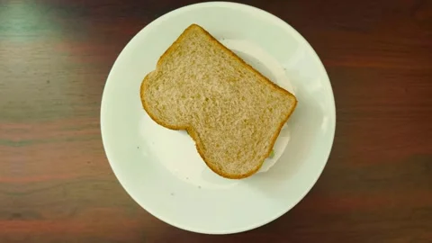 Wide angle top down view of sandwich on a plate placed on a wooden texture backg Video stock 318257948