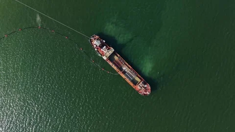 Wide angle top view of dredging ship and pipeline Stockbeeldmateriaal 338187463