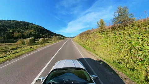 Wide-angle top view white car riding fast speeding along highway in rural Stock Footage 167919271