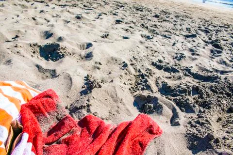 Wide angle towel on the beach, with hat and sunglasses. Stock Photos