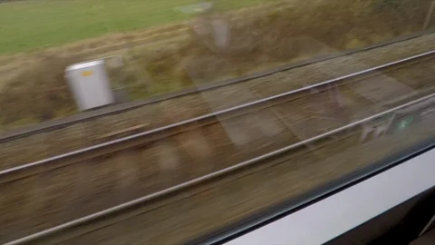 Wide Angle of A Train Traveling Along Train Tracks as Another Train Passes By Stock Footage 113990422