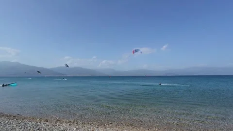 Wide angle turquoise beach with distant kitesurfer in Greece Stock Footage 337046177