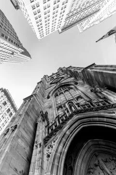 Wide angle upward view of Trinity Church at Broadway and Wall Street with Stock Photos