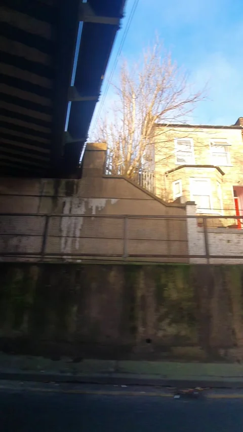 Wide Angle Vertical Footage of British Urban City Streets During Car Drive Vídeo Stock 327451115