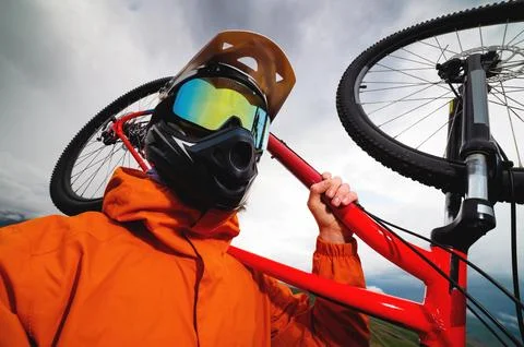 Wide angle vertical frame top angle. Portrait of a bearded mountain biker with Stock Photos