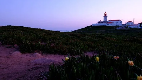 Wide angle video of Cabo da Roca Lighthouse over the cliffs at dusk, Portugal Stock Footage 105656250