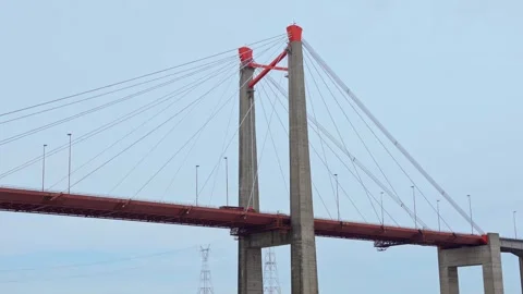 Wide angle video of a massive cable-stayed bridge crossing a wide river Stock Footage 345936295