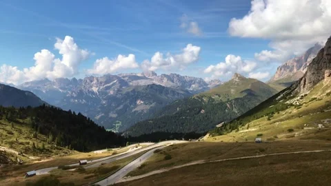 Wide-angle view of alpine valley with winding road in Dolomites Italy Video stock 342519809
