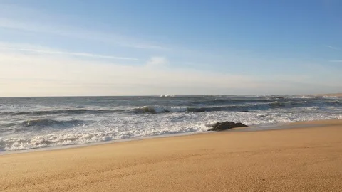 Wide angle view of beach on sunny day with blue sky and white wispy clouds Stock Footage 103279160