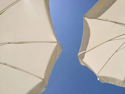 Wide angle view of beach umbrellas close up sunny day Stock Photos