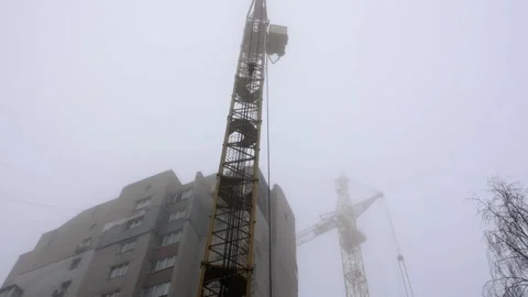 A wide angle view from below of a construction crane on a foggy day. Stock Footage 230919516