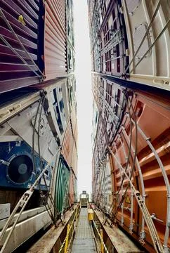Wide Angle View Between Stacked Shipping Containers on Container Ship, Global Lo Stock Photos