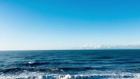 Wide Angle View of Blue Ocean Waves Under Clear Sky with Copy Space Stock Footage 331710713