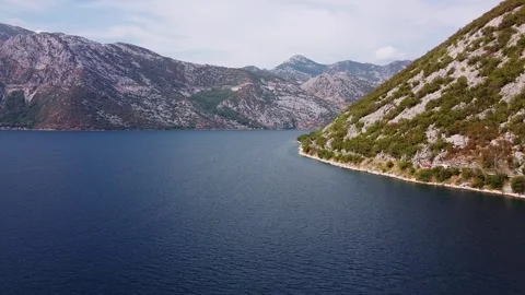 Wide-angle view of calm bay surrounded by Mediterranean mountains Video stock 342770936