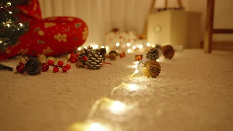 Wide Angle View of Christmas Tree on Carpet with String Lights Leading Toward Stock Footage 316771100